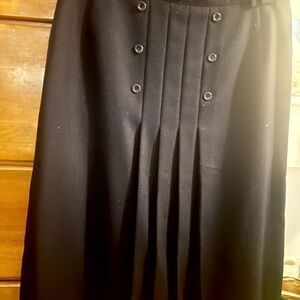 Navy Blue Buttoned and pleated in front, loops for belt. Tailored lined skirt.